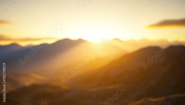Fototapeta A serene sunrise over a mountain range, capturing soft light and tranquil beauty in nature's backdrop.