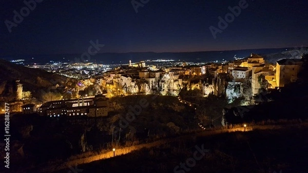 Obraz The old town of Cuenca with its iconic Hanging Houses illuminated at night, Castilla-La Mancha, Spain, offering a stunning view of architectural and historical charm
