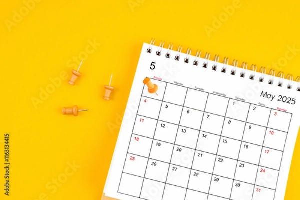 Obraz May 2025 Monthly desk calendar for 2025 year with wooden pin on yellow background.