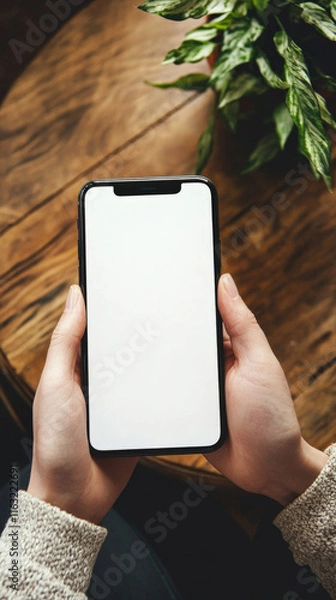 Obraz A customizable phone mockup with a blank screen, ideal for showcasing app interfaces, website designs, or branding concepts in a sleek, modern setting.