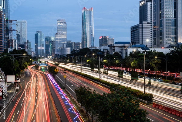 Fototapeta Jakarta, Indonesia: Long exposure of traffic in the heart of Jakarta business and financial district in Indonesia capital city at dusk.