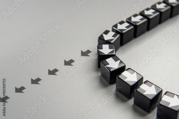 Obraz A row of black cubes with white arrows pointing in different directions. A change in course or a shift in strategy concept.