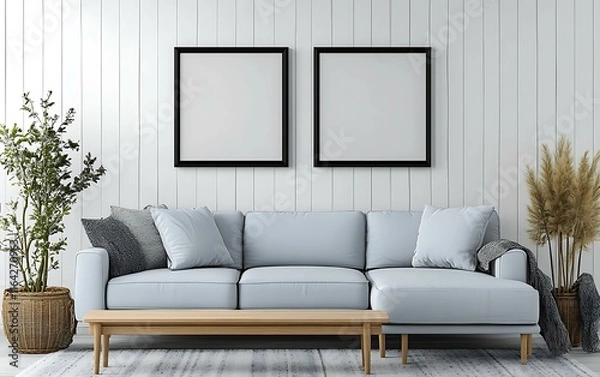 Fototapeta Light blue sectional sofa, two blank frames, plants, and wooden coffee table in a minimalist white room.