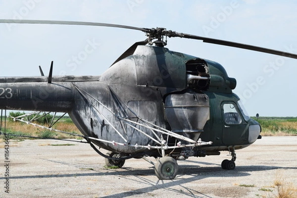 Fototapeta Old helicopter spraying fields