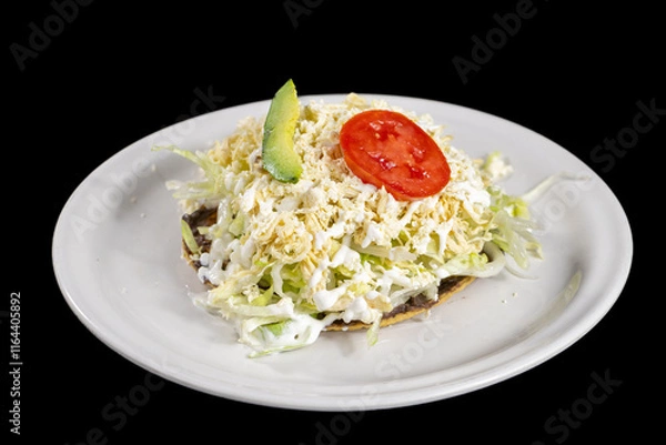 Fototapeta Chicken tostada with beans, lettuce, tomatoes, avocado in a white dish