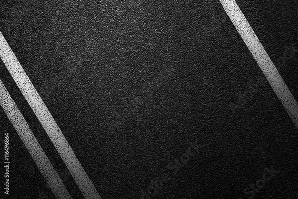 Fototapeta Level asphalted road with a dividing white stripes. The texture of the tarmac, top view.