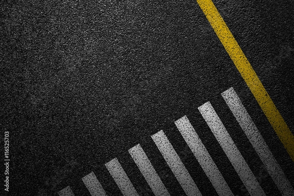 Fototapeta Level asphalted road with a dividing stripes and pedestrian crossing. The texture of the tarmac, top view.
