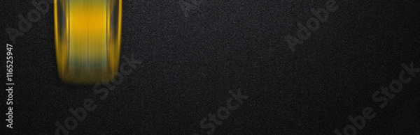 Fototapeta Smooth asphalt road and moving with high speed a yellow car. The texture of the tarmac, top view.