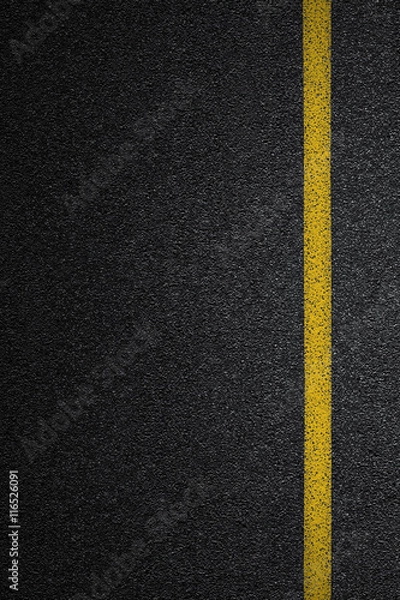 Fototapeta Level asphalted road with a dividing yellow stripes. The texture of the tarmac, top view.