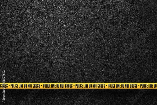 Fototapeta Yellow police line in the background smooth asphalt road. Do not cross. The texture of the tarmac, top view.