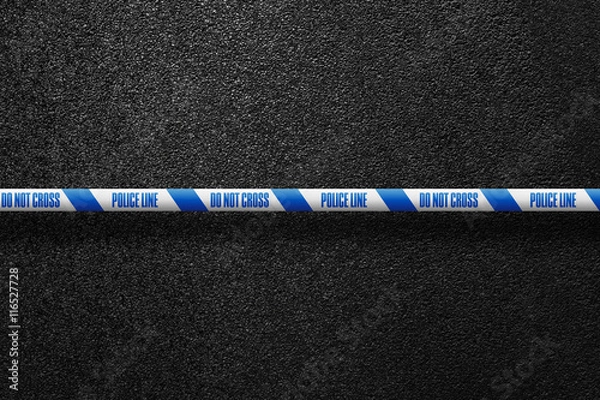 Fototapeta English white-blue police line in the background smooth asphalt road. Do not cross. The texture of the tarmac, top view.