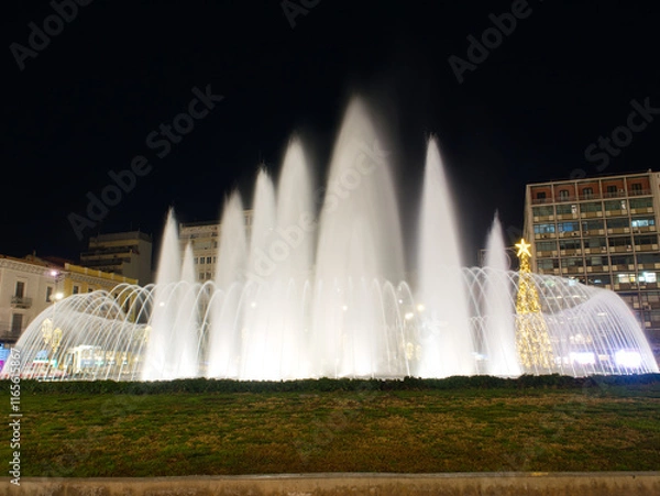 Fototapeta Illuminated fountains in Omonoia Square Athens
