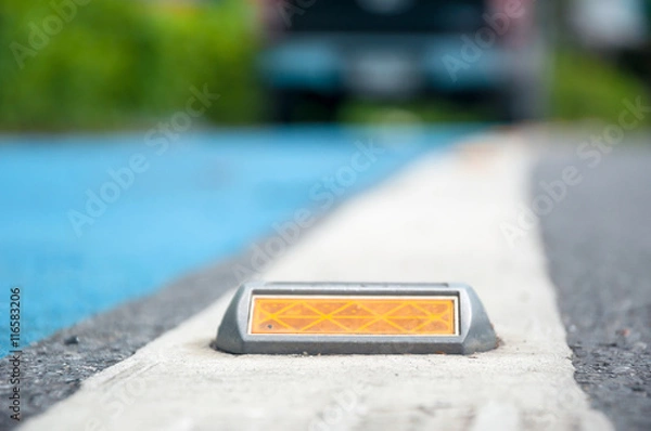 Obraz the soft focus of reflector or stud on asphalt road