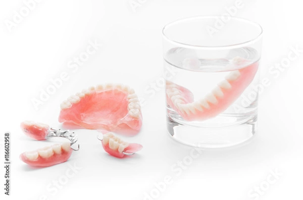 Obraz Set of Denture in glass of water on white background