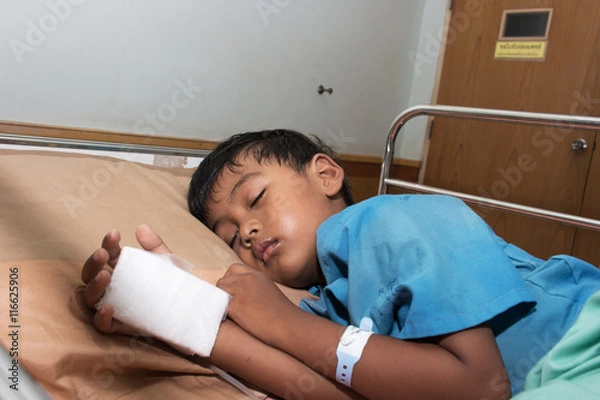 Fototapeta Little boy sick in the Hospital with saline intravenous