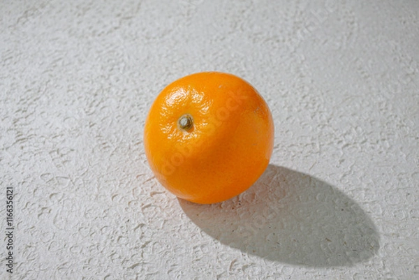 Fototapeta A vibrant orange isolated on a clean white background, representing freshness, health, and natural citrus goodness, ideal for food related visuals