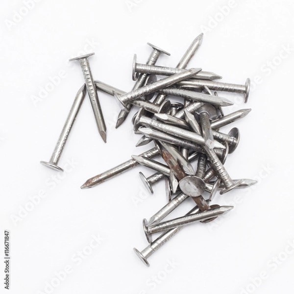 Fototapeta Closeup of a pile of rivets, nails isolated on white background