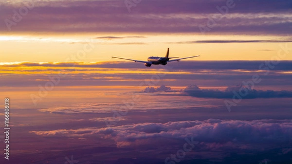 Obraz Plane is flying through the sky with a beautiful sunset in the background