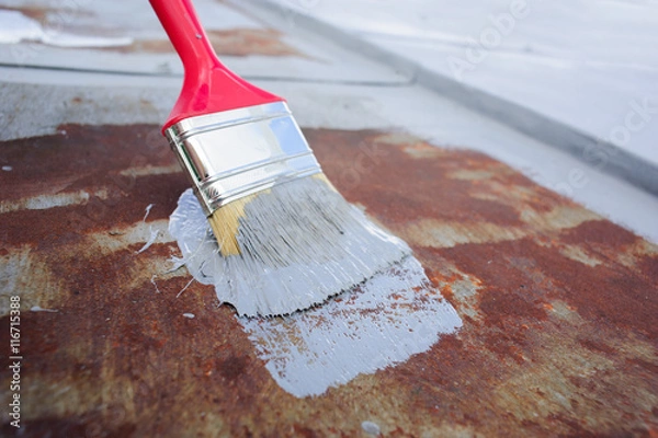 Obraz paint brush with paint on the rusty iron