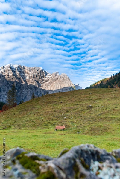 Fototapeta Colorful autumn landscape at Großer Ahornboden in the Karwendel Mountains, Austria – forest with fall foliage, rocky peaks and dramatic sky