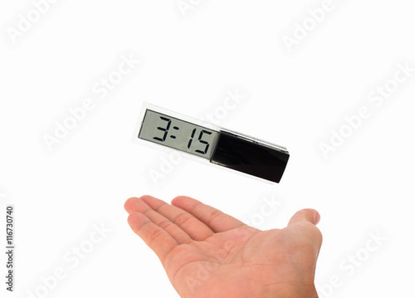 Obraz Time control: A clock floating in air above a hand isolated on white background
