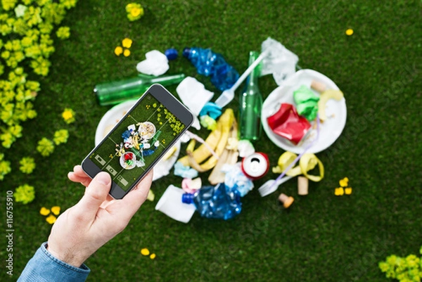Fototapeta Man taking a picture of garbage