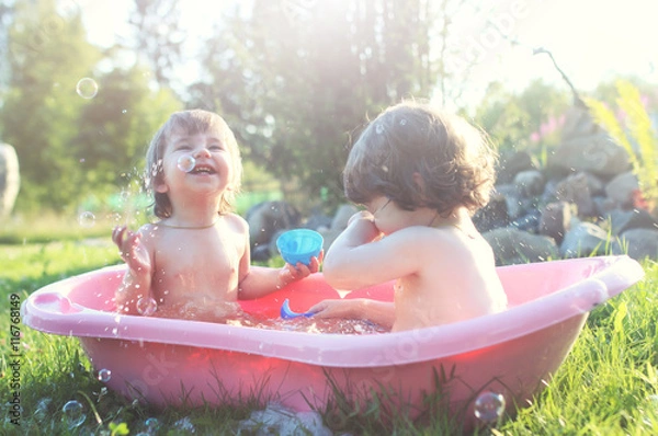 Fototapeta kids in bath water outdoor