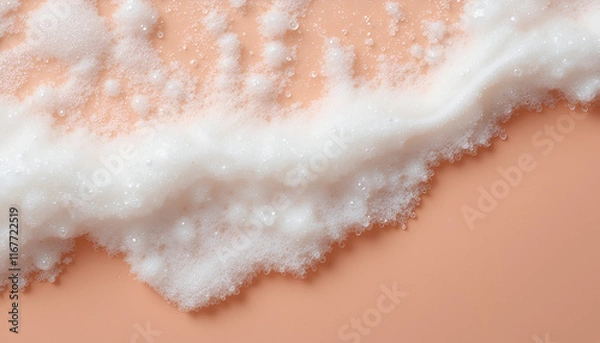 Fototapeta 
Close-up of soap suds and bubbles created from shampoo, lotion, and detergent. Close-up image of foam on a peach backdrop. Banner featuring area for text