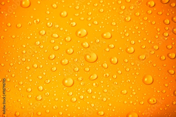 Obraz Drops of water on a color background. Orange. Shallow depth of f
