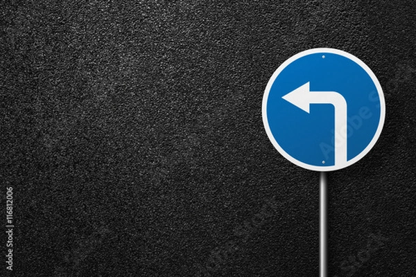 Fototapeta Road sign of the circular shape with pointer on a background of asphalt. Detour. The texture of the tarmac, top view.
