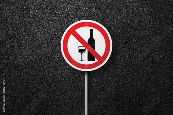 Fototapeta Road sign of the circular shape on a background of asphalt. No alcohol. The texture of the tarmac, top view.