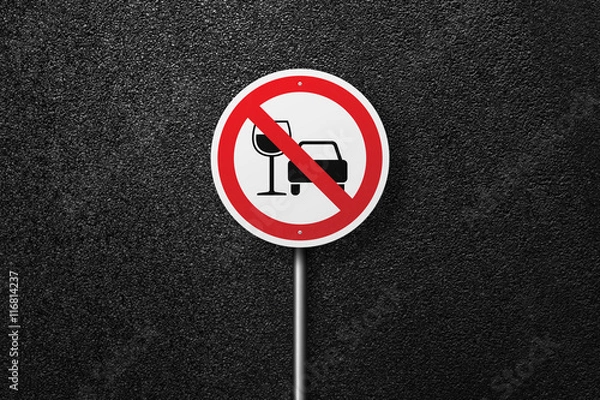 Fototapeta Road sign of the circular shape on a background of asphalt. No alcohol. The texture of the tarmac, top view.