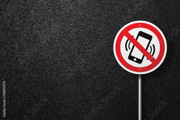 Fototapeta Road sign of the circular shape on a background of asphalt. No phones and sms. The texture of the tarmac, top view.