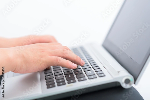 Fototapeta Hands typing on keyboard of laptop.