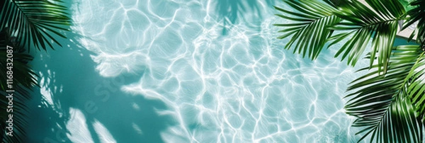 Fototapeta A top-down view of a crystal-clear swimming pool with rippling water reflecting sunlight, creating soft waves and patterns