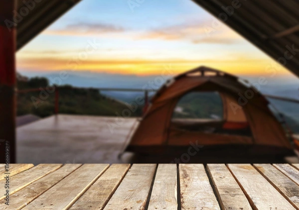 Obraz Wooden table top on blur tent camping travel tent and grass field.Fresh and Relax concept.For montage product display or design key visual layout.View of copy space.