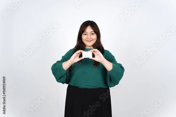 Fototapeta Holding Credit Debit Card, Smiling and showing white blank card, Pay or Shopping Concept Of Beautiful Asian Woman wearing green Isolated On White Background
