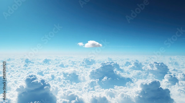 Fototapeta Stunning view from above the clouds with a single cloud and a vibrant blue sky