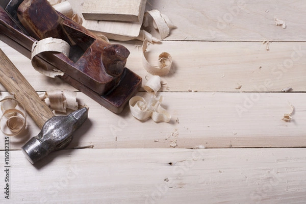 Obraz Construction tools on wooden table with sawdust. Joiner carpenter workplace top view. Copy space for text
