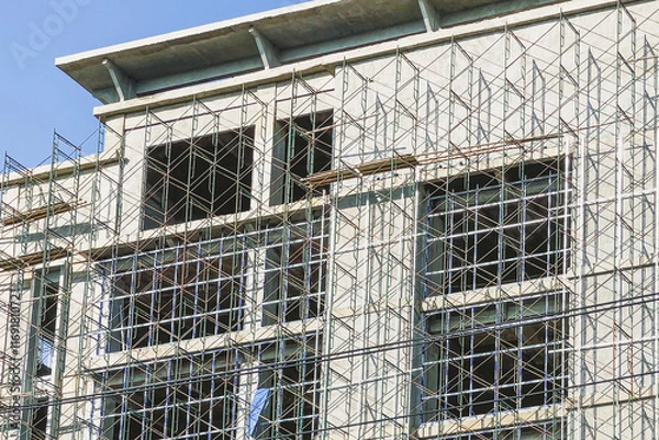 Obraz Multi storey building with construction scaffolding lock