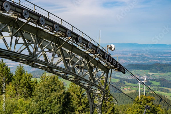 Obraz View Over a large deflection pulley of the Schauinsland cable car over Freiburg and the Rhine Valley to the Vosges Mountains