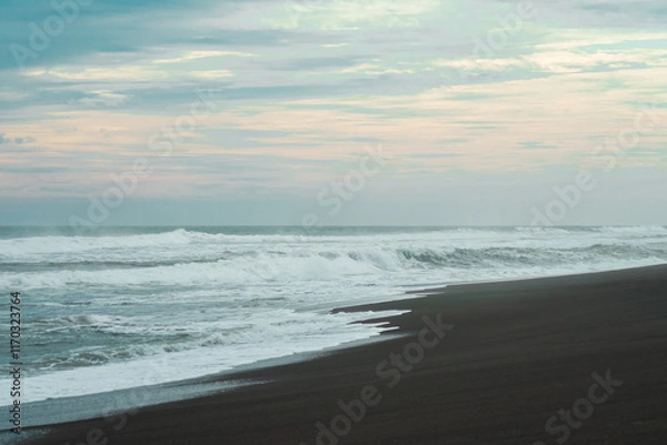 Obraz waves breaking on the beach. Ocean waves breaking on a  beach. Close up shot of breaking wave Pandansari beach, Central Java, Indonesia.