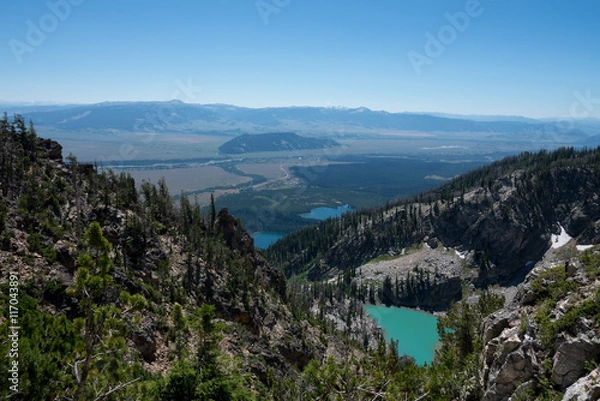 Fototapeta The view of the valley below from the upper elevation of the Grand Teton National Park in Wyoming.