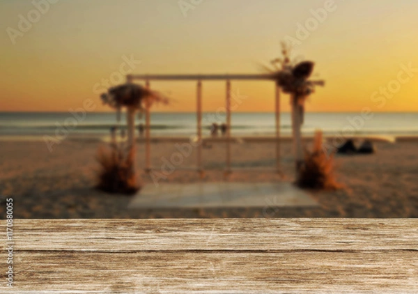 Obraz Wooden table top on the beach or sea.Party on the beach  sunset time concept.For montage product display or design key visual layout.View of copy space.