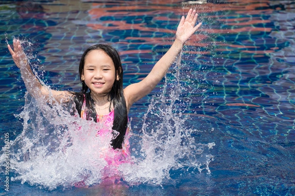 Fototapeta Asia kid girl at the pool and smiling happy