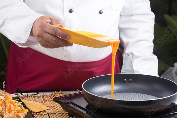 Obraz chef pouring egg to pan