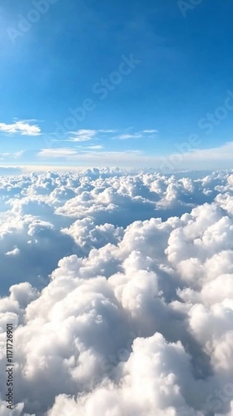 Fototapeta A serene view of fluffy clouds against a bright blue sky.