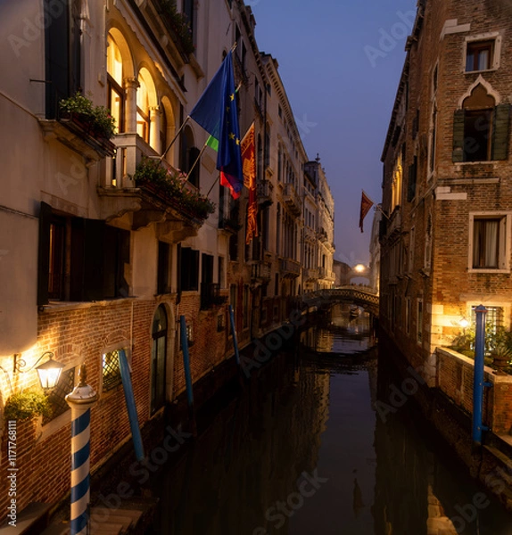 Fototapeta Venetian canal in the evening. Reflection of the medieval city in the water.