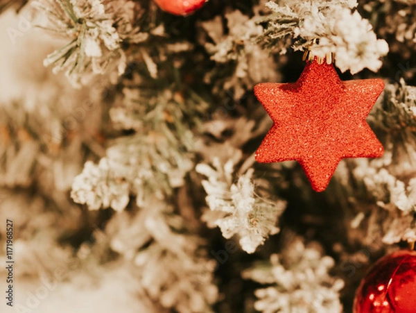 Fototapeta Christmas tree decorations on branches of Christmas tree. Decorations in form of red balls and hexagonal star on decorative Christmas tree. Celebrating New Year. December 31, 2024 - Pula, Croatia