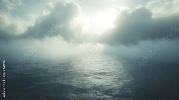 Fototapeta Misty ocean scene with sun peeking through clouds.